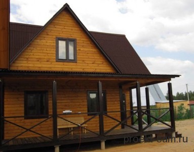 деревянный дом с открытой террасой и мансардой