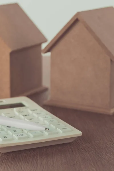 Small Wooden Houses Calculator Pen Wooden Tabletop Saving Concept — стоковое фото